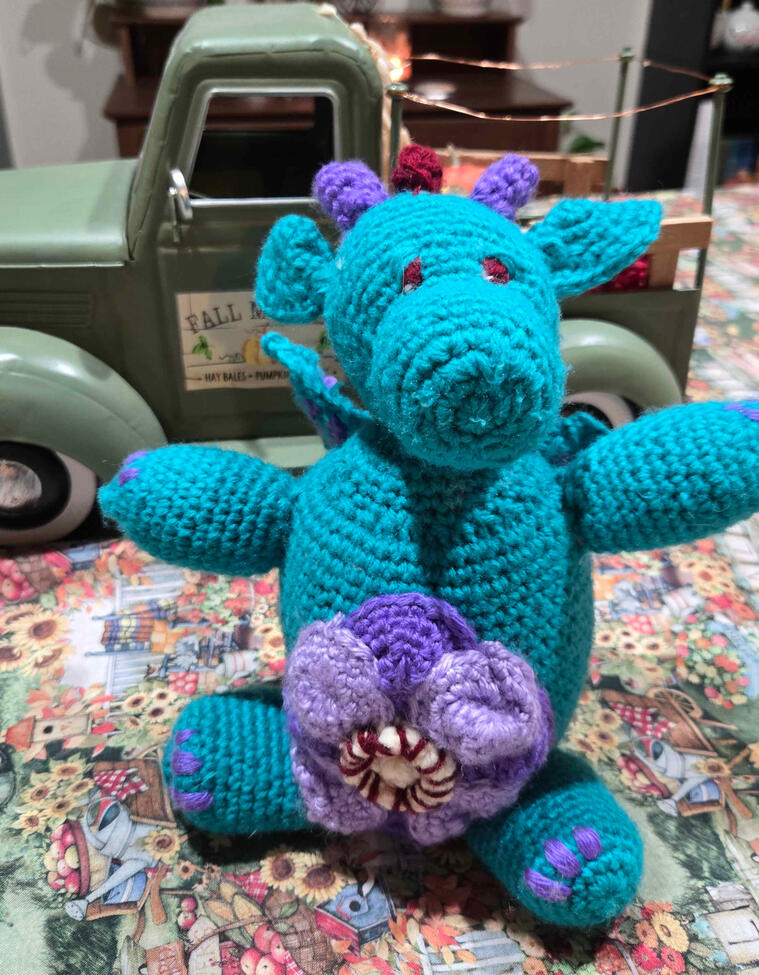 This is Peanut! He is a river dragon and he loves flowers. He was crocheted with acrylic yarn. He is not for sale, but I do sell crocheted dolls! See VGen for pricing!